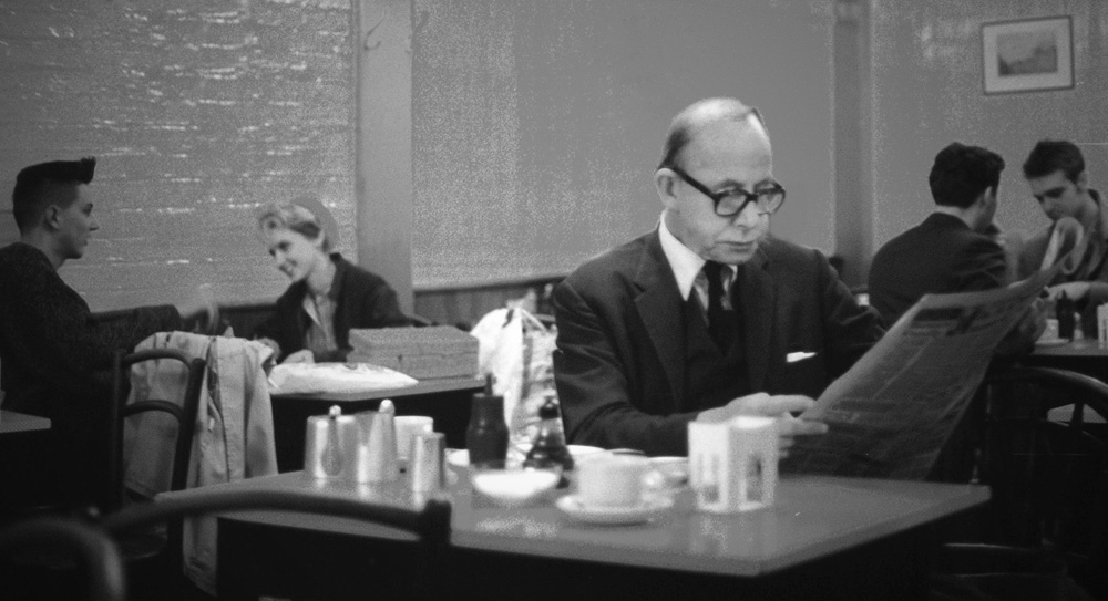 Mann mit Zeitung im Café